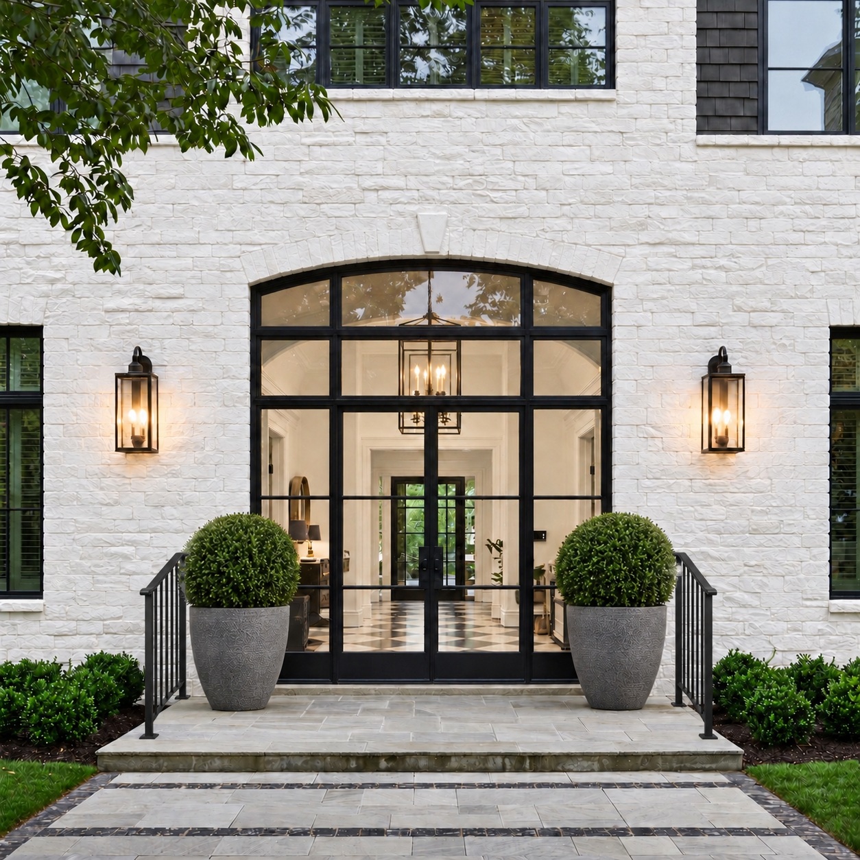 Bel Air residence entrance with white brick, black-framed doors, and small black step railings
