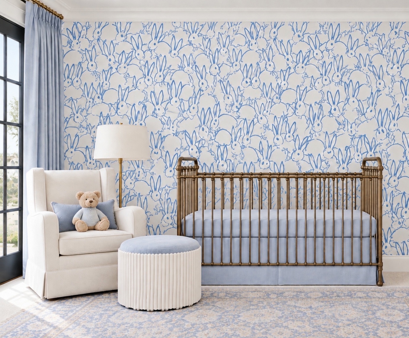 Nursery with blue patterned wallpaper and upholstered reading chair