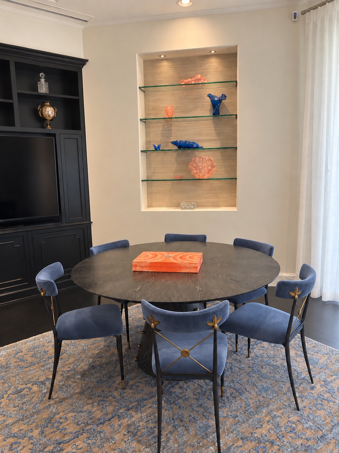 Game table beside illuminated display shelving