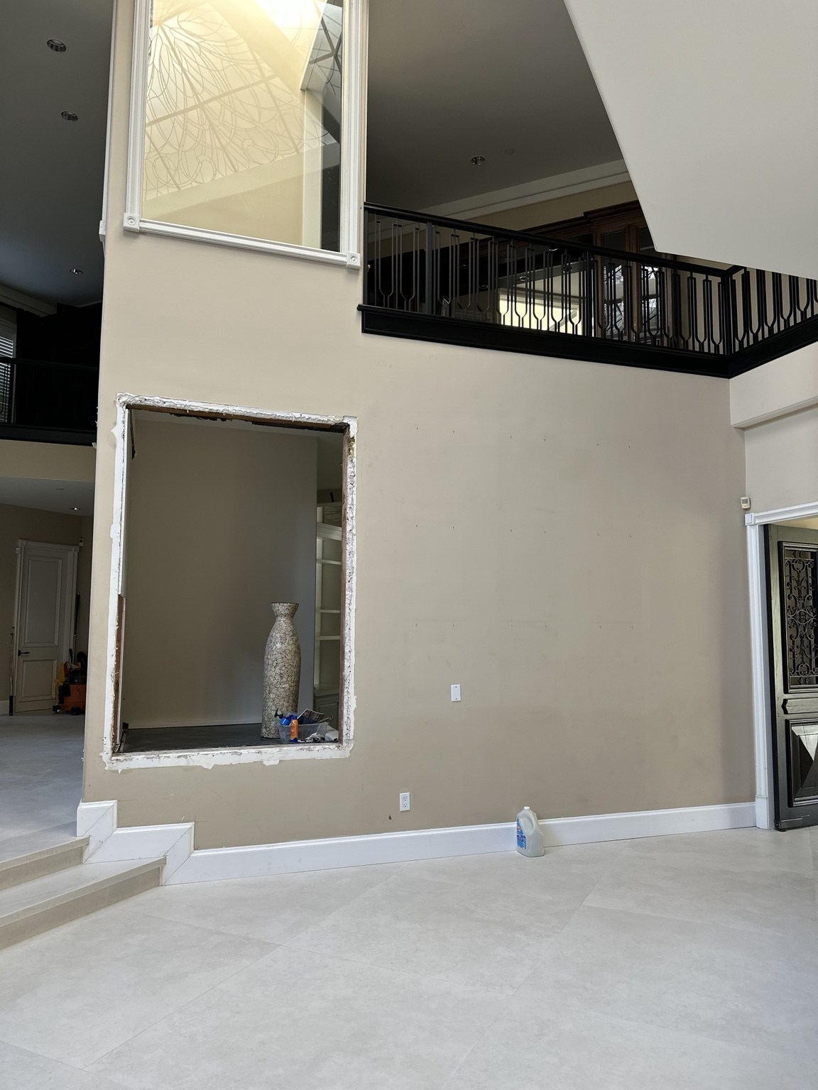 Interior wall work beneath the upper-level gallery