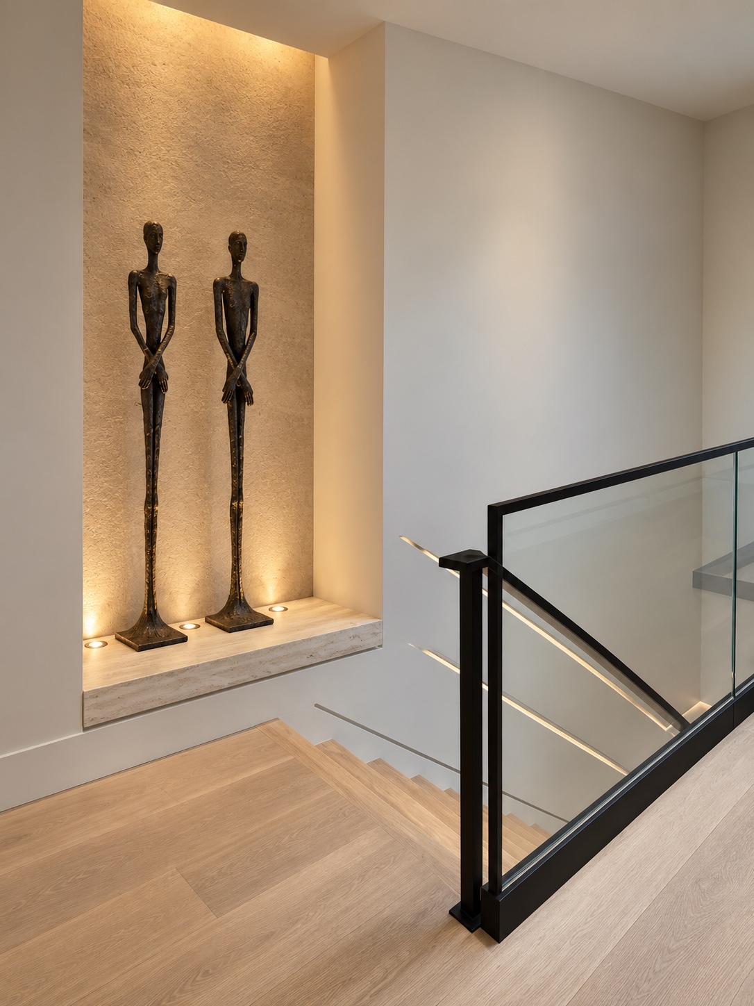 Stair landing with illuminated sculpture niche