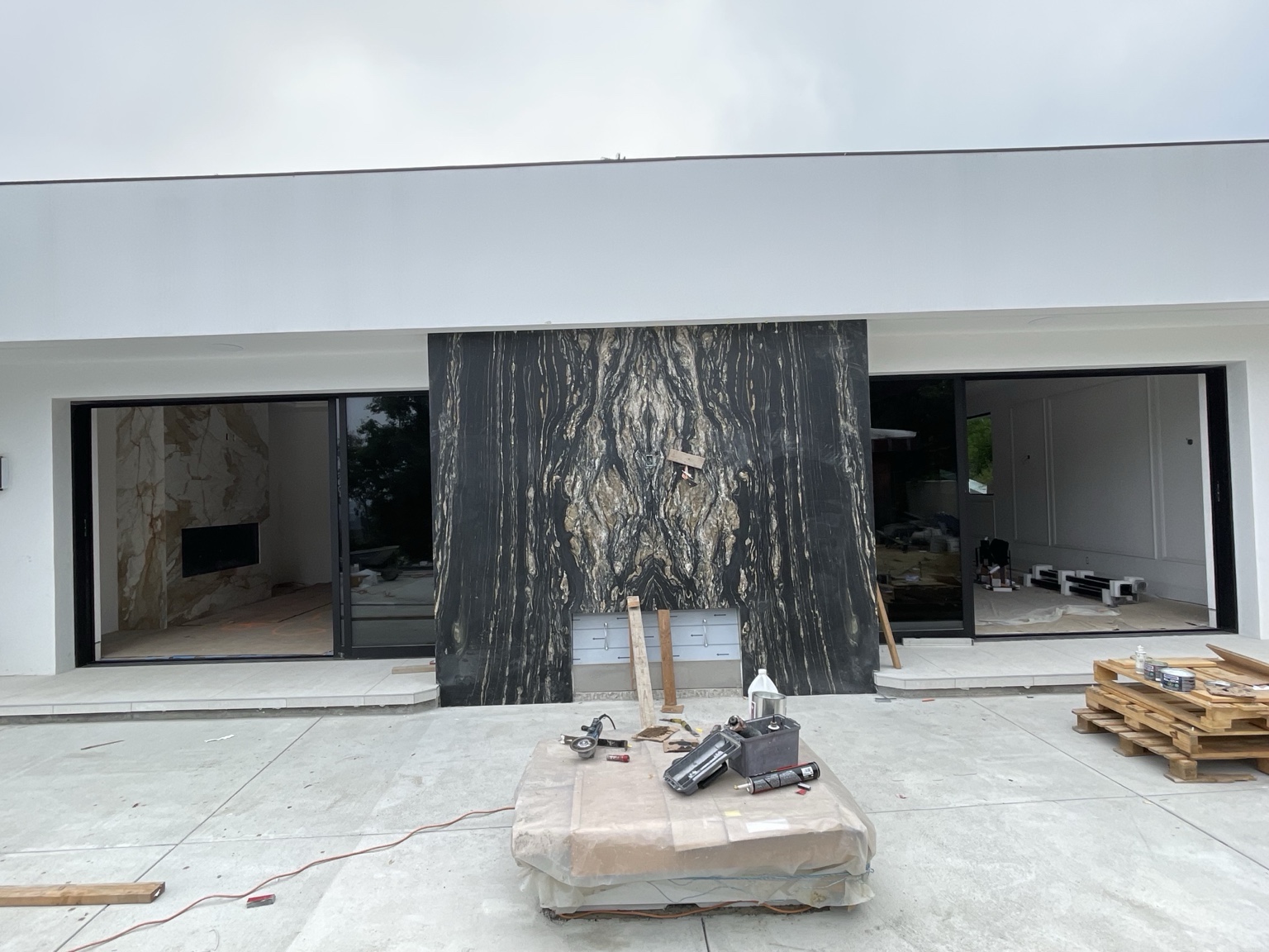 Outdoor fireplace stone installation during construction